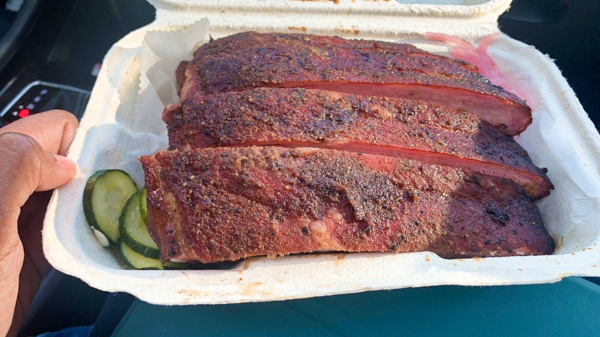 Three pieces of dry rub ribs on a storage pack from Mutiny BBQ
