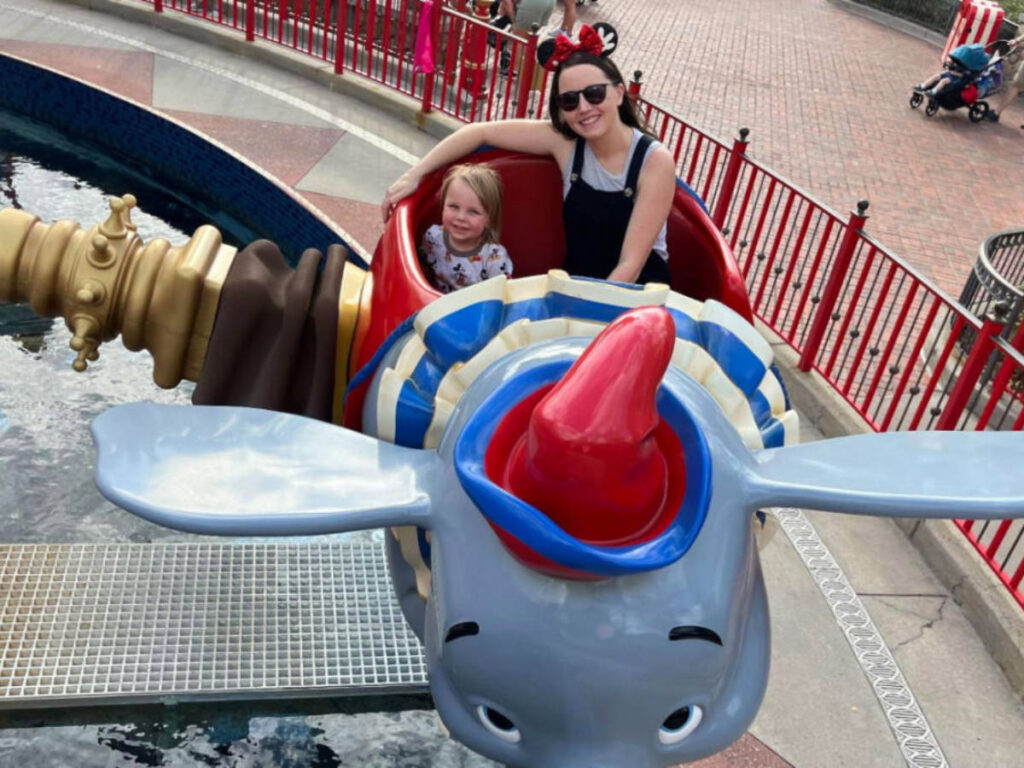 Travel Lemming writer, Katie Neufeld with her son on the Dumbo ride