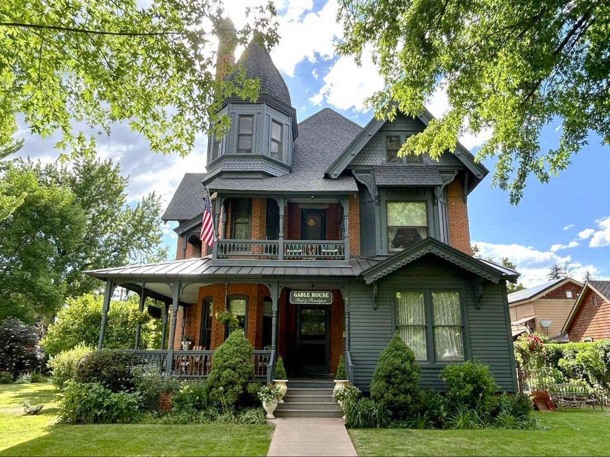 Exterior view of the Gable House surrounded by lush greenery