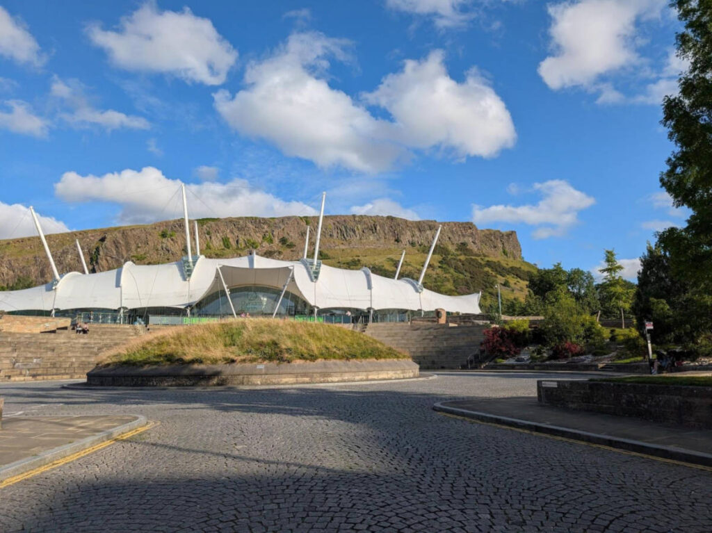Panoramic view of the Dynamic Earth with the Salisbury Crags in the background