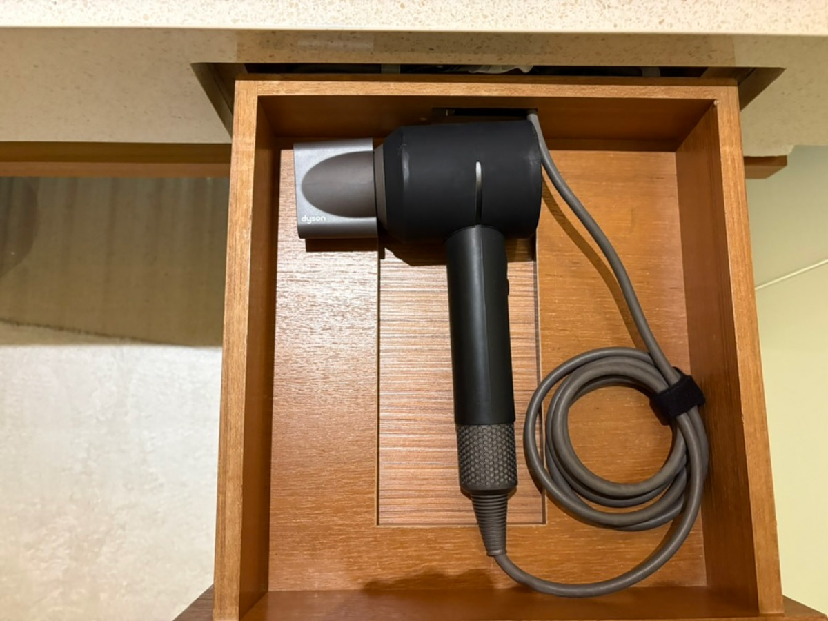 A Dyson blow dryer inside the drawer