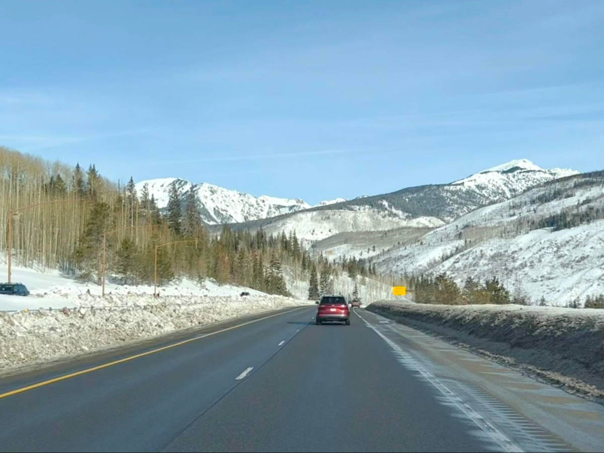 A lone car driving along the Vail Pass