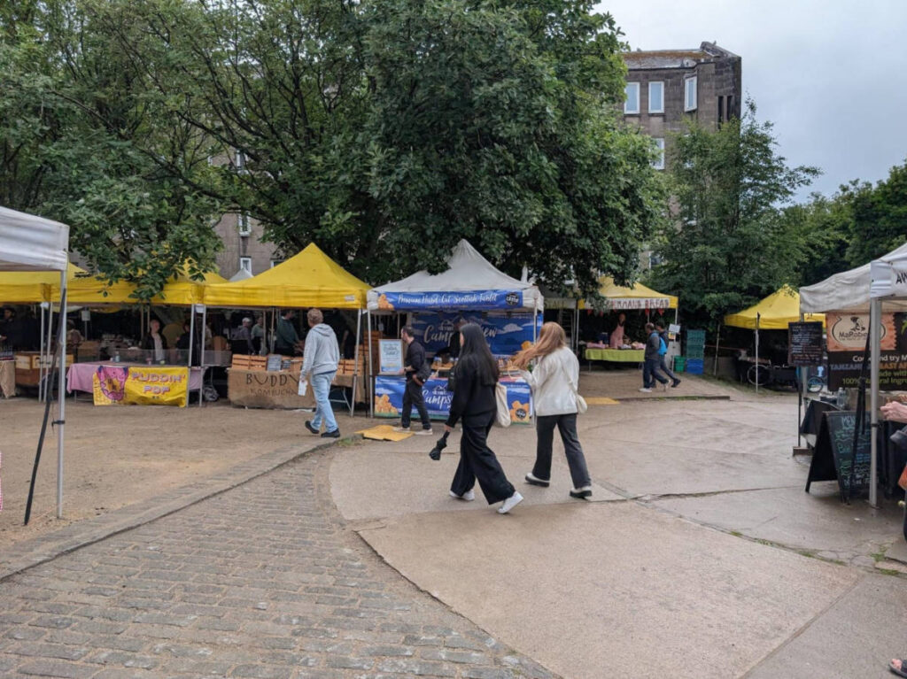 People walking around the Stockbridge Market in Edinburgh