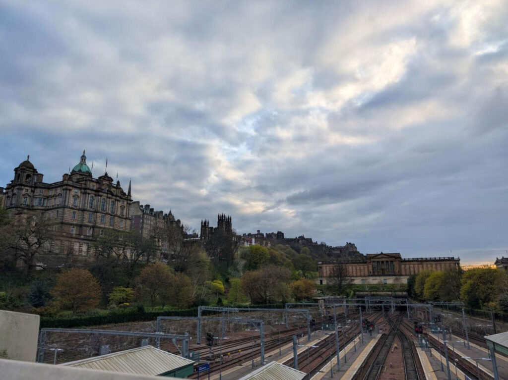 View of Edinburgh Waverley train station surrounded by historic stone buildings
