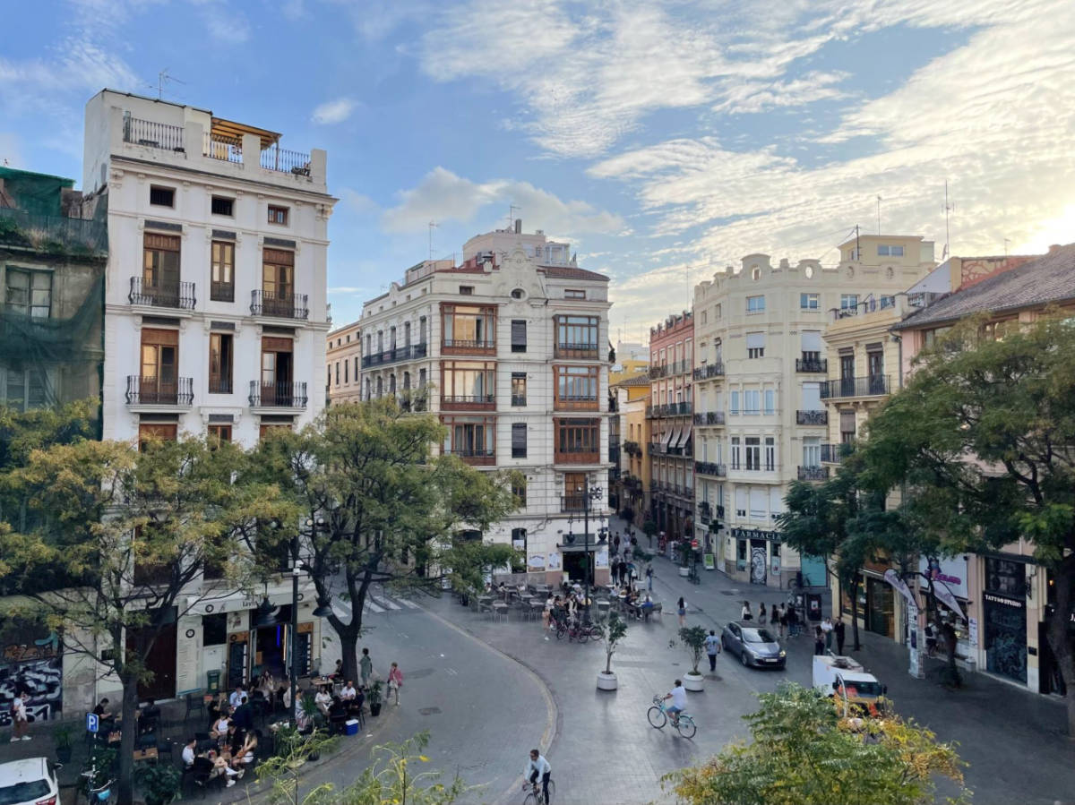 View of the architectural infrastructures and people crossing in the street of the El Carmen neighborhood