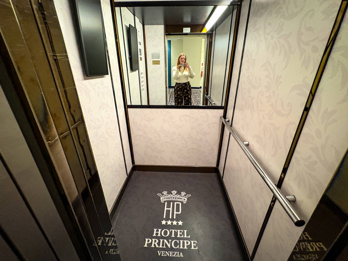 The author, Taylor Herperger taking a mirror selfie at the elevator in Hotel Principe