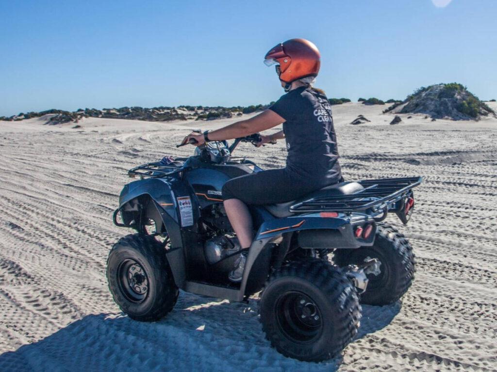 The author Elise Kirsten, riding on a quad biking at the Atlantis Dunes