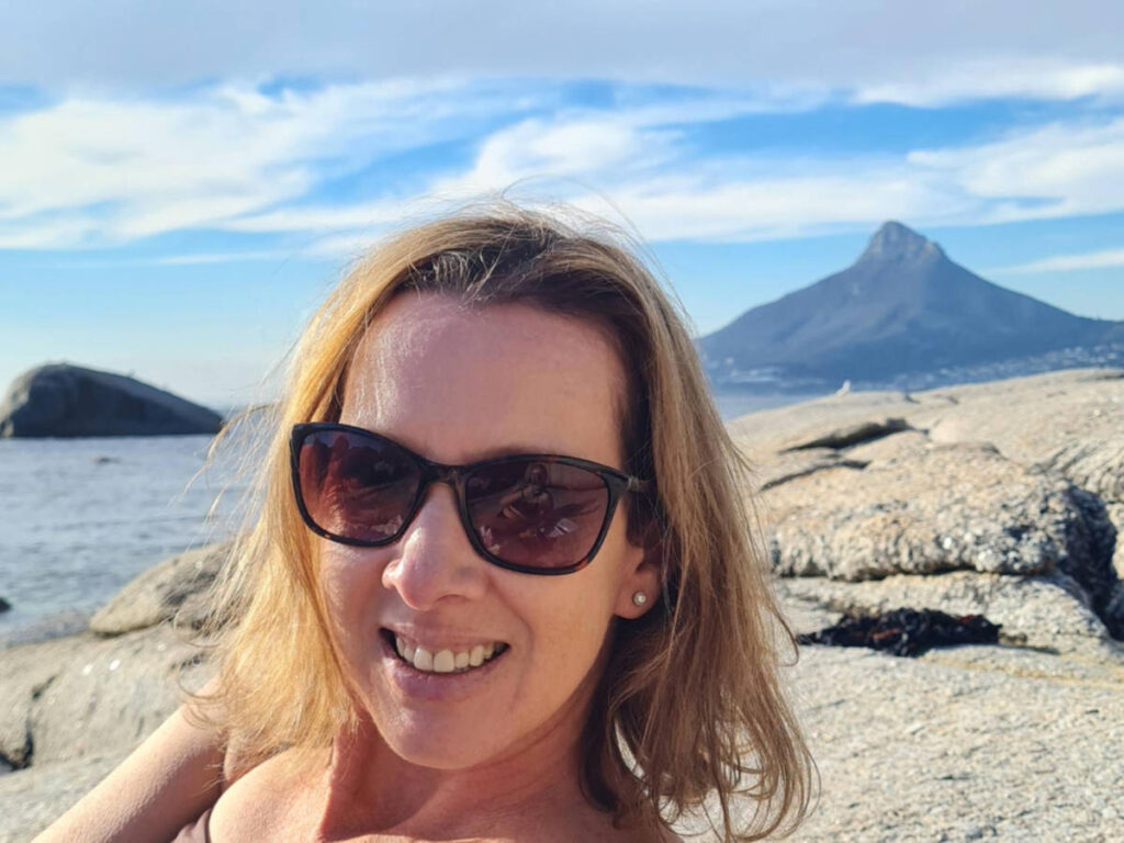The author Elise Kirsten, relaxes on a rock with Lion’s Head view