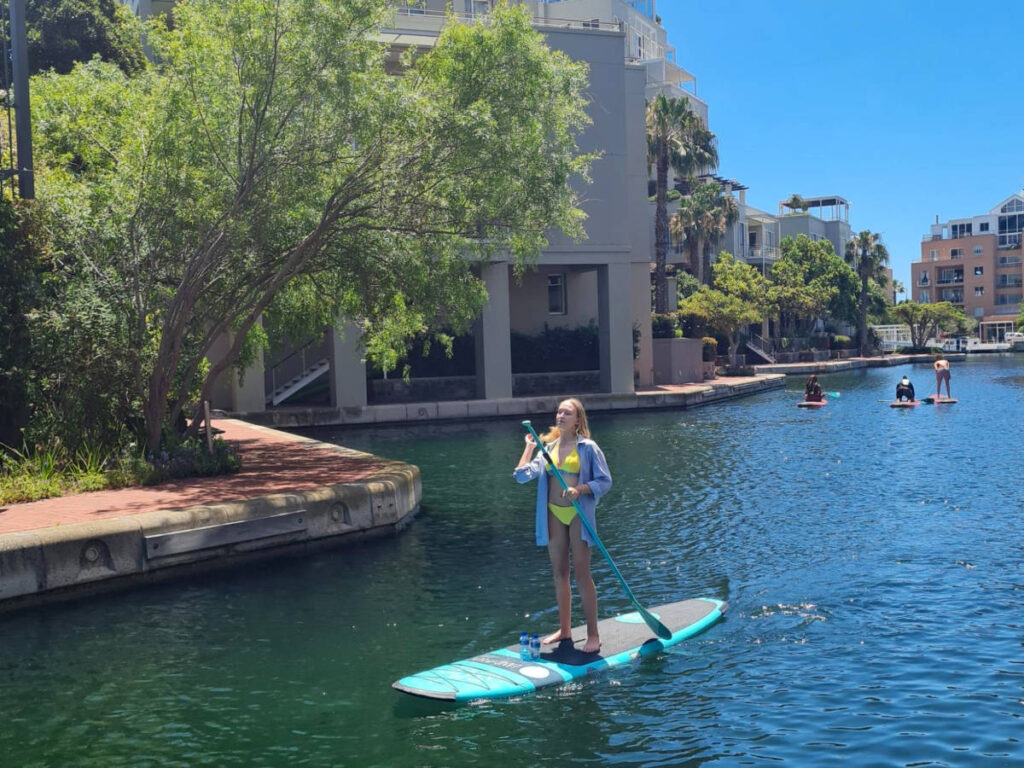 The author's daughter on a stand-up paddleboard on the Waterfront Canals