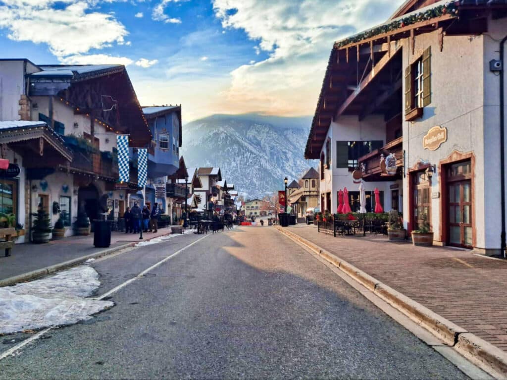 View of the peaceful street of Leavenworth with mountain views in the background