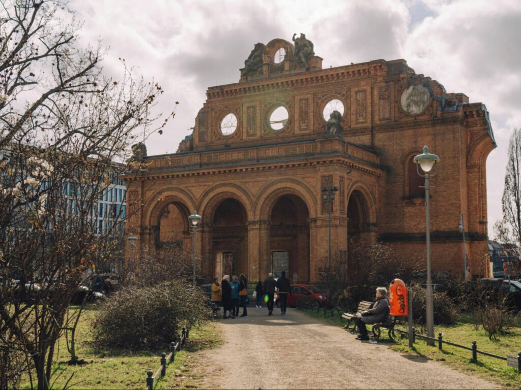 People entering the red brick entrance around the Berlin Story Bunker