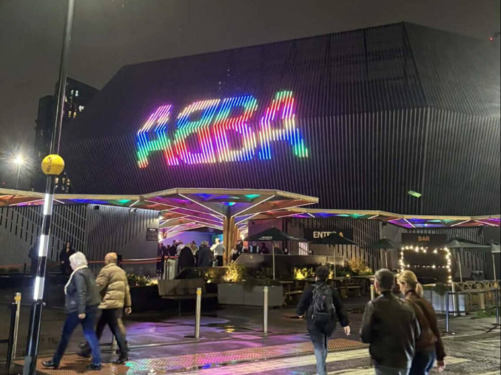 The colorful LED sign of ABBA at the entrance of ABBA Voyage