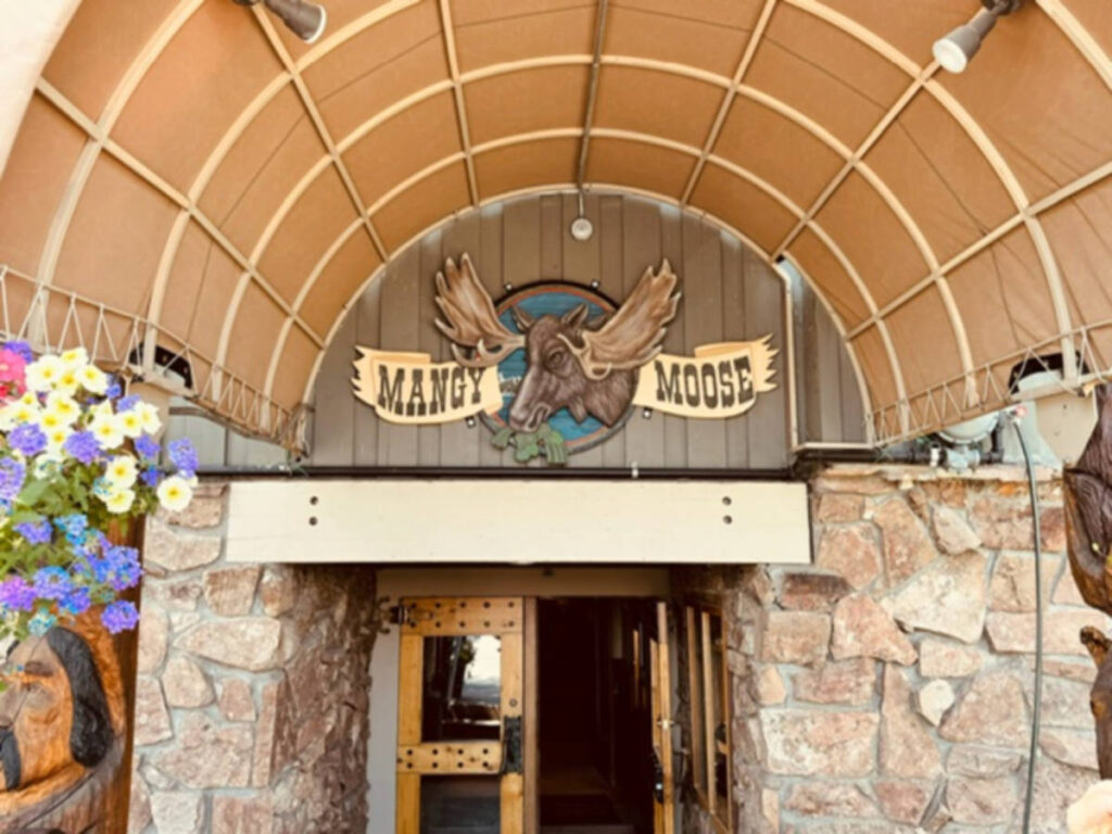 View of the signage at the entrance to the Mangy Moose Saloon