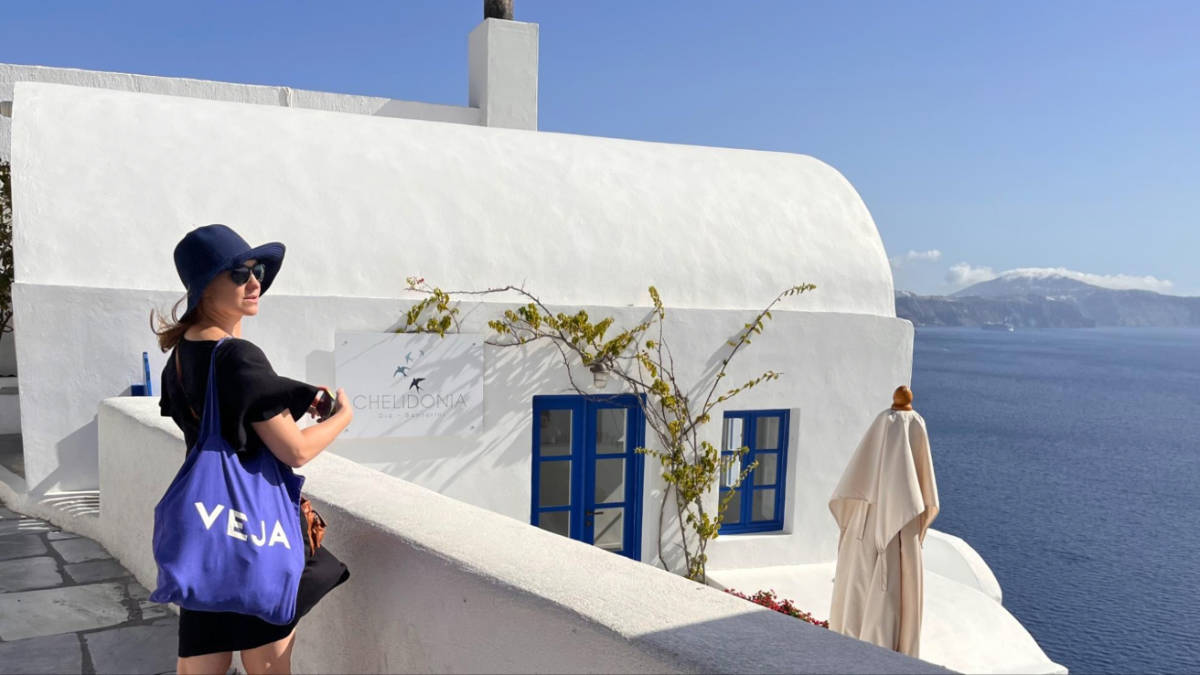 The author Erin Henk, admiring the coastal views in Santorini