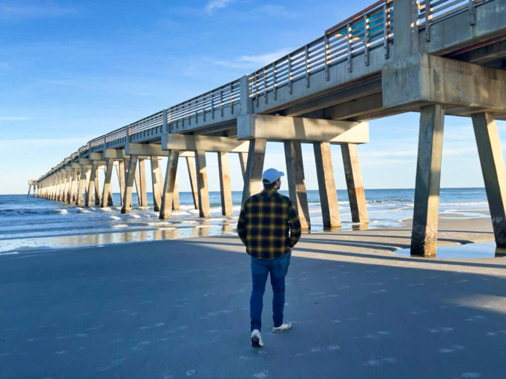 The author Ethan Thoren, walking along the shoreline at Jacksonville Beach