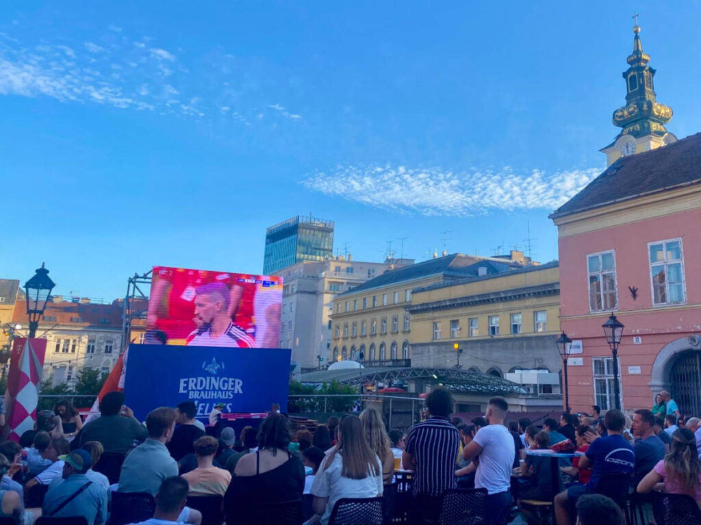 People watching the quarterfinal of the 2024 Euro Championship at an outdoor bar in Zagreb