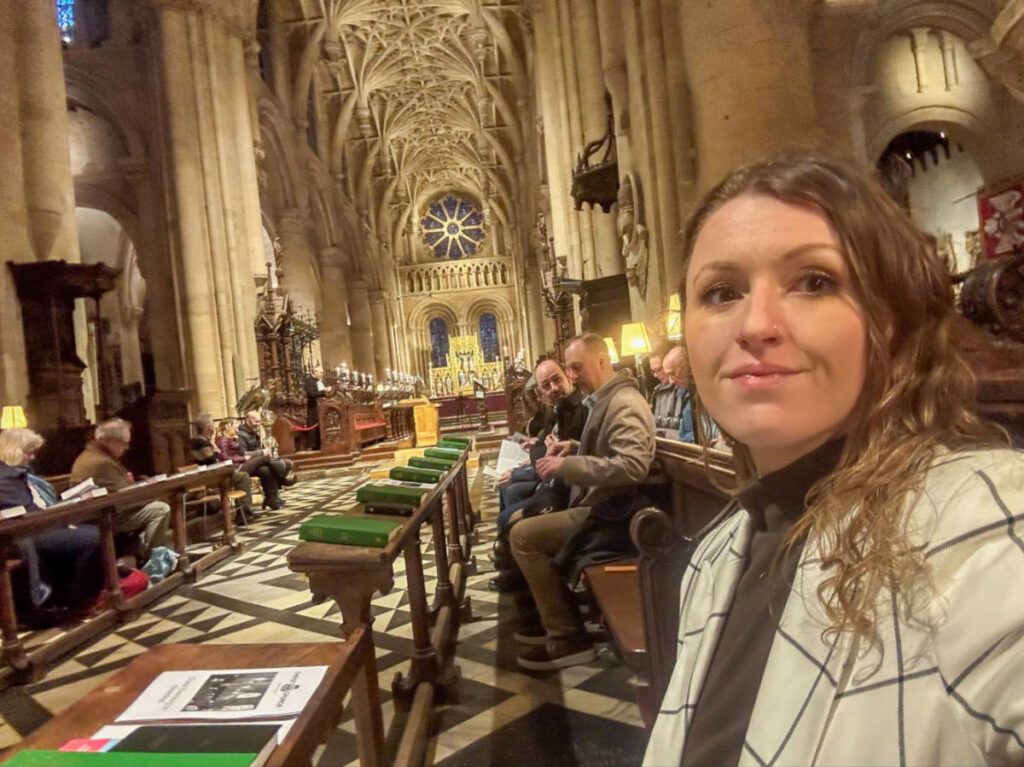 The author Rebecca Rayner, sitting inside the Christ Church Cathedral