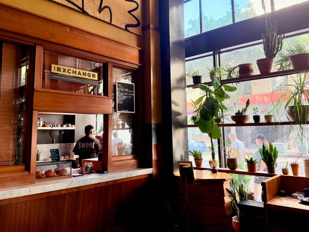 View of the barista preparing and the cozy interior of Exchange Coffee Co.