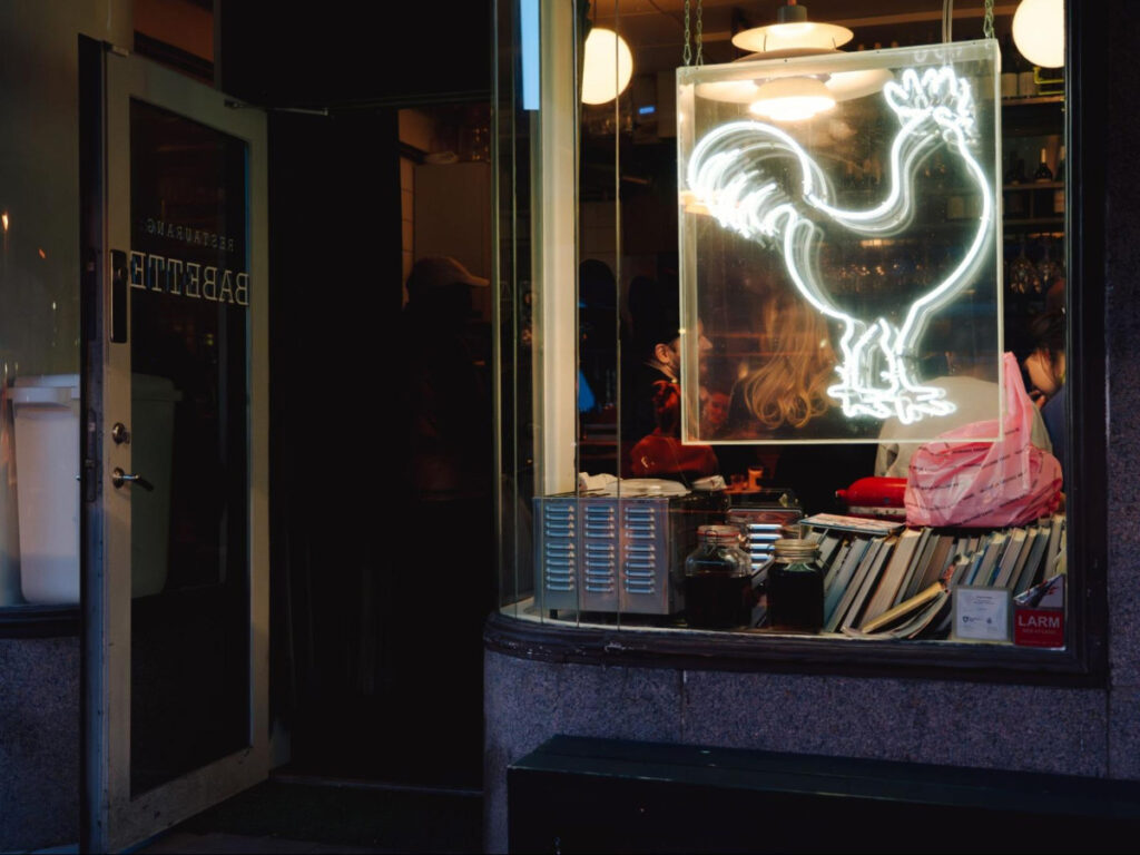 A neon sign outside the pizzeria Babette