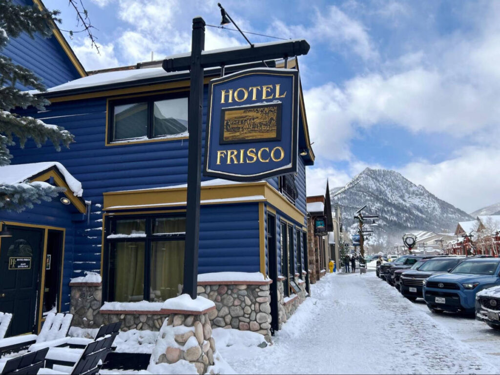 View of the exterior of Hotel Frisco and the snowyscape around