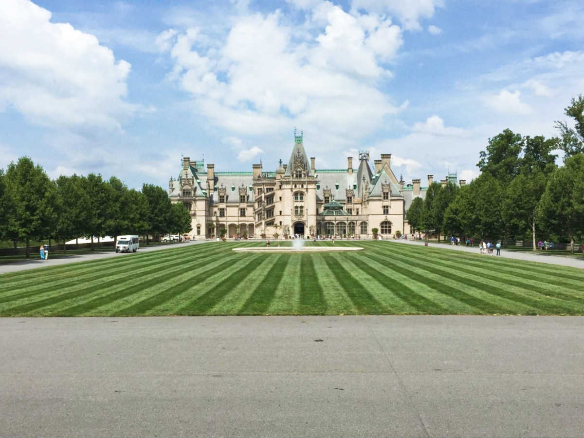 The Biltmore House & Estate and its wide greenspace on the foreground