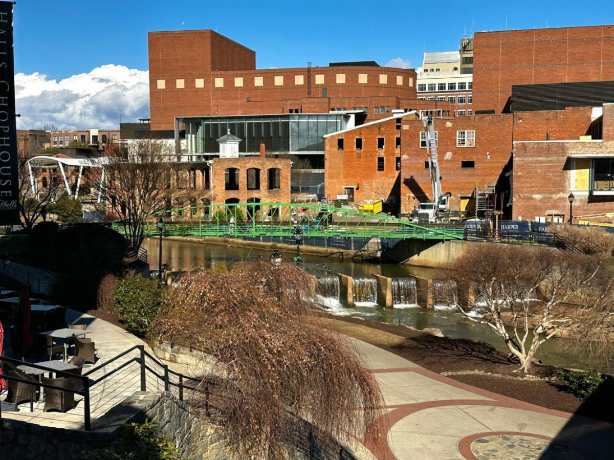 View of the buildings around and a bridge at the Falls Park on the Reedy River