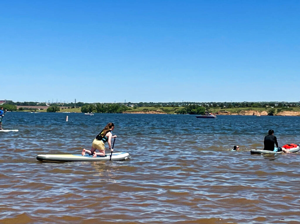 People paddleboarding on the ocean on a sunny day
