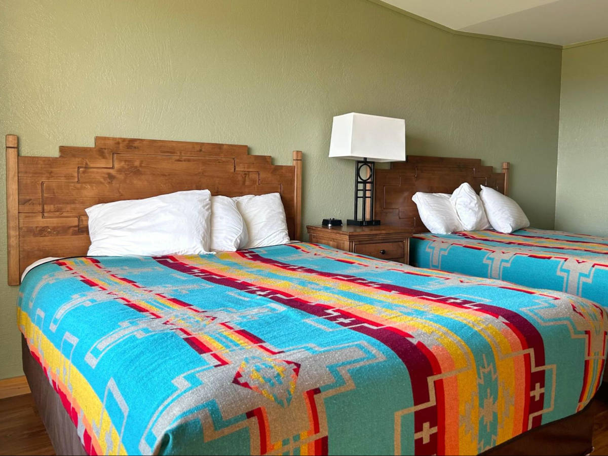View of the colorful sheets on the two beds in Far View Lodge