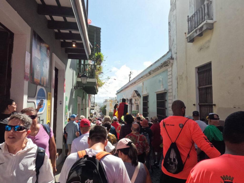 Crowd walking along in an alley during the Fiestas de la Calle San Sebastian festival