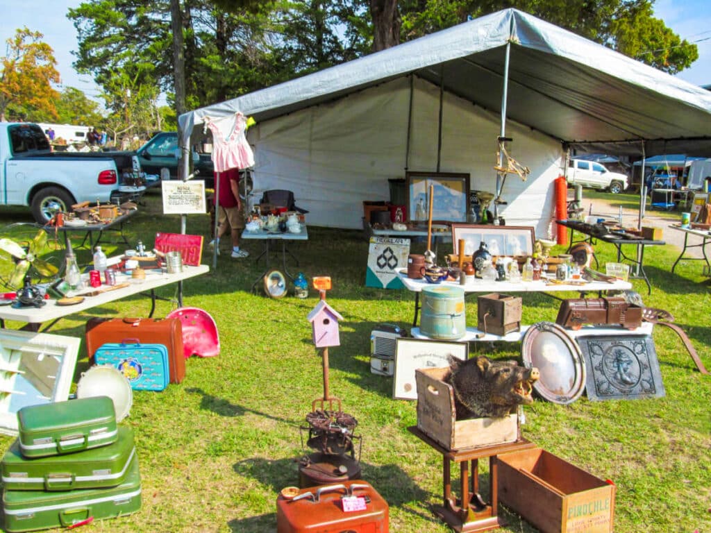 A tent with different things displayed at the flea market