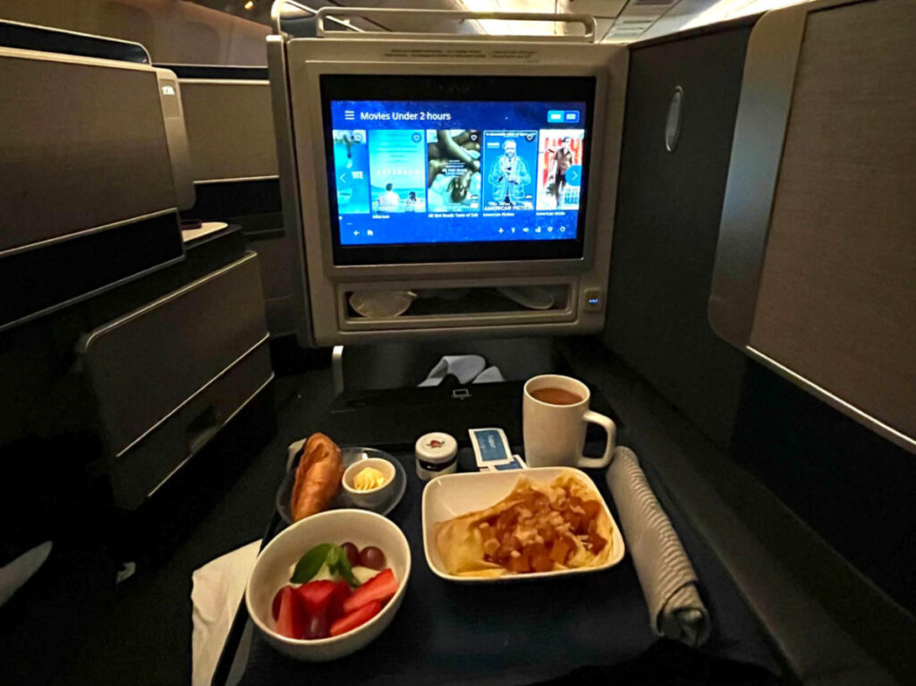 The meal and entertainment on a First class airplane seat