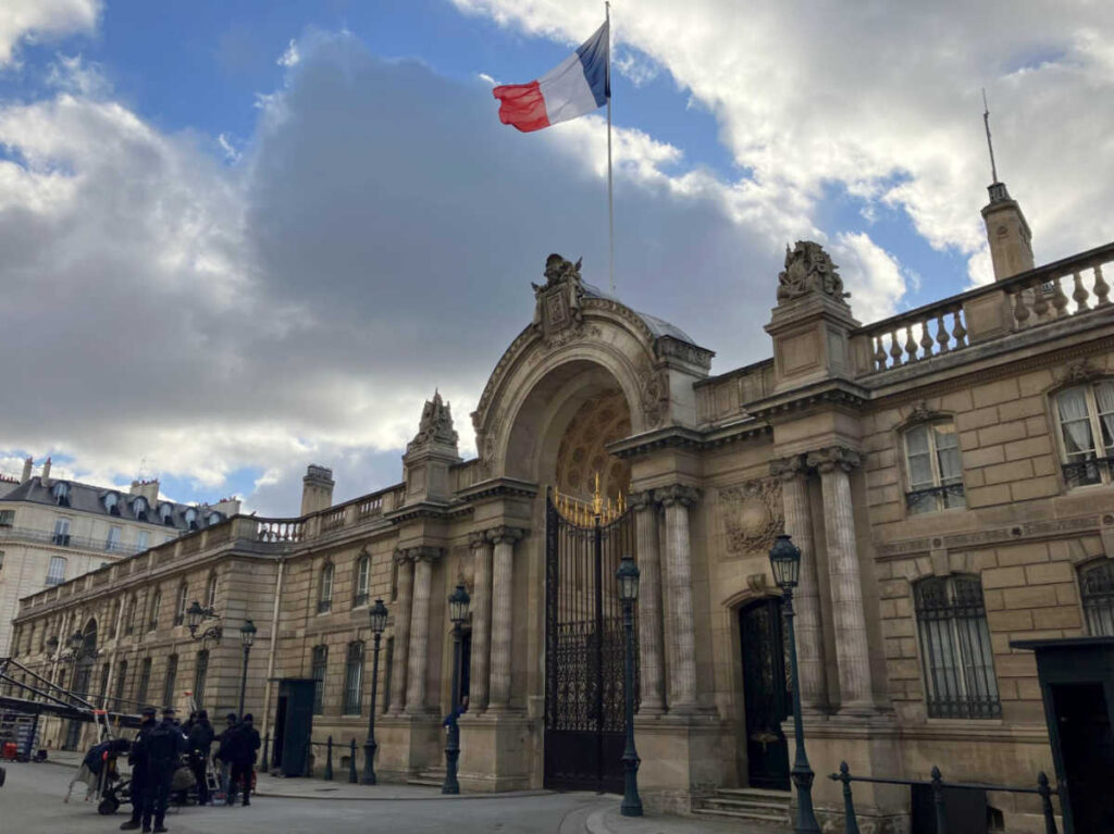 The flag of France on top of the gate of The Elysée Palace on a gloomy day