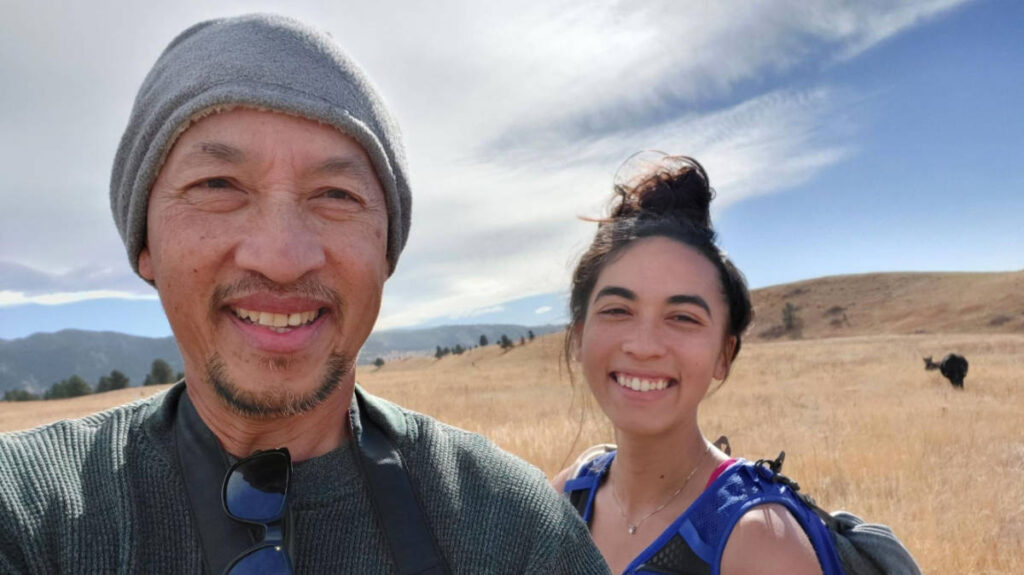 The author with her father smiling for a selfie in Flatirons Vista during autumn season