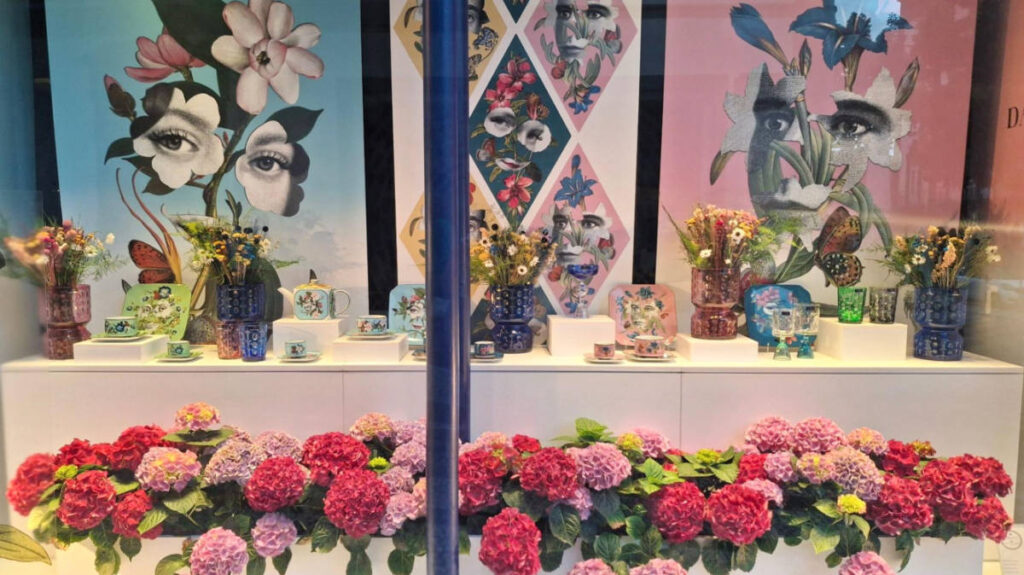 View of the decorated storefront surrounded by blooming flowers