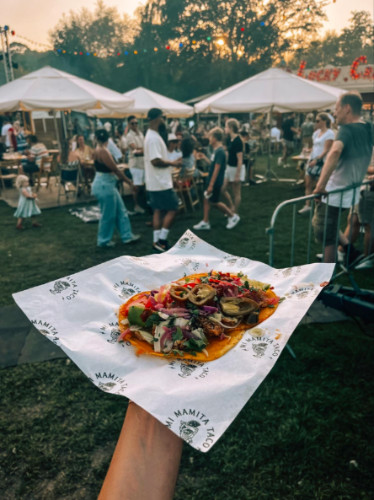 Holding a food from Festival Trek