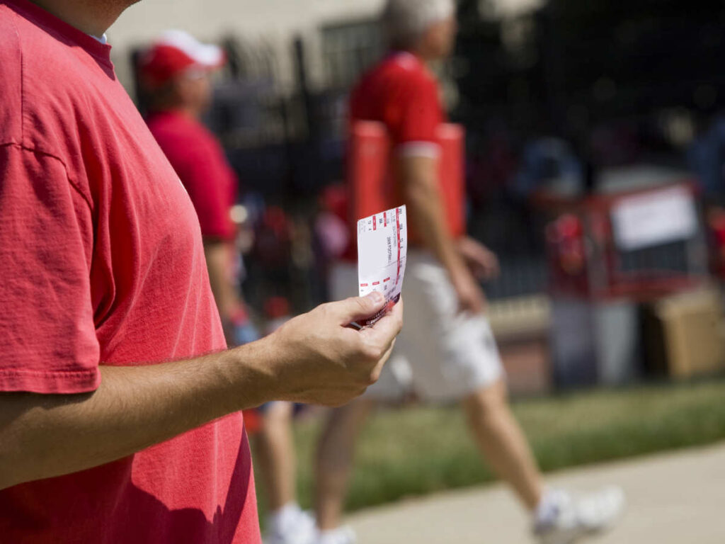A football fan holding a ticket