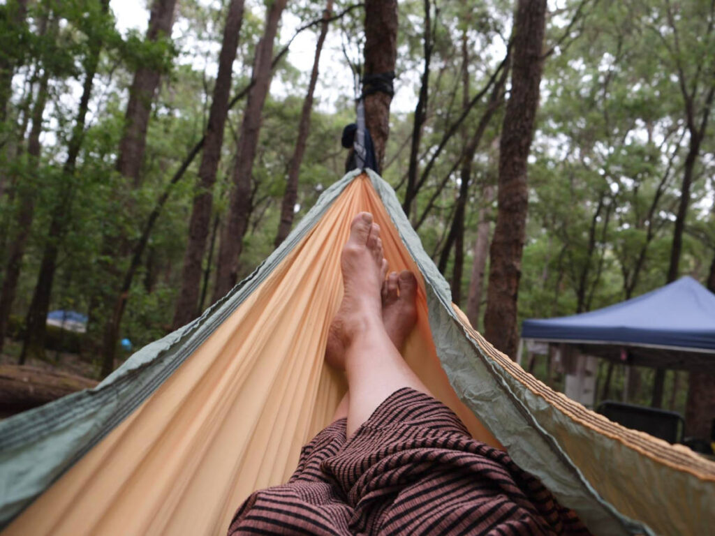 View of the feet on the hammock in the forest