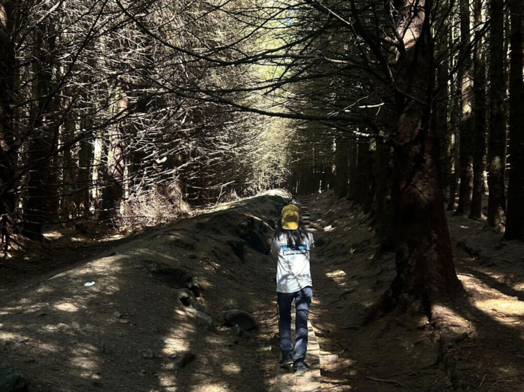 Editor Abigail standing at the Forested trails of Wicklow Mountains