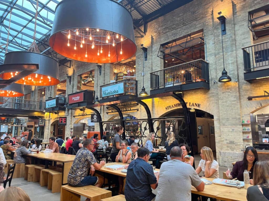 People enjoying their foods and drinks at the Forks Common