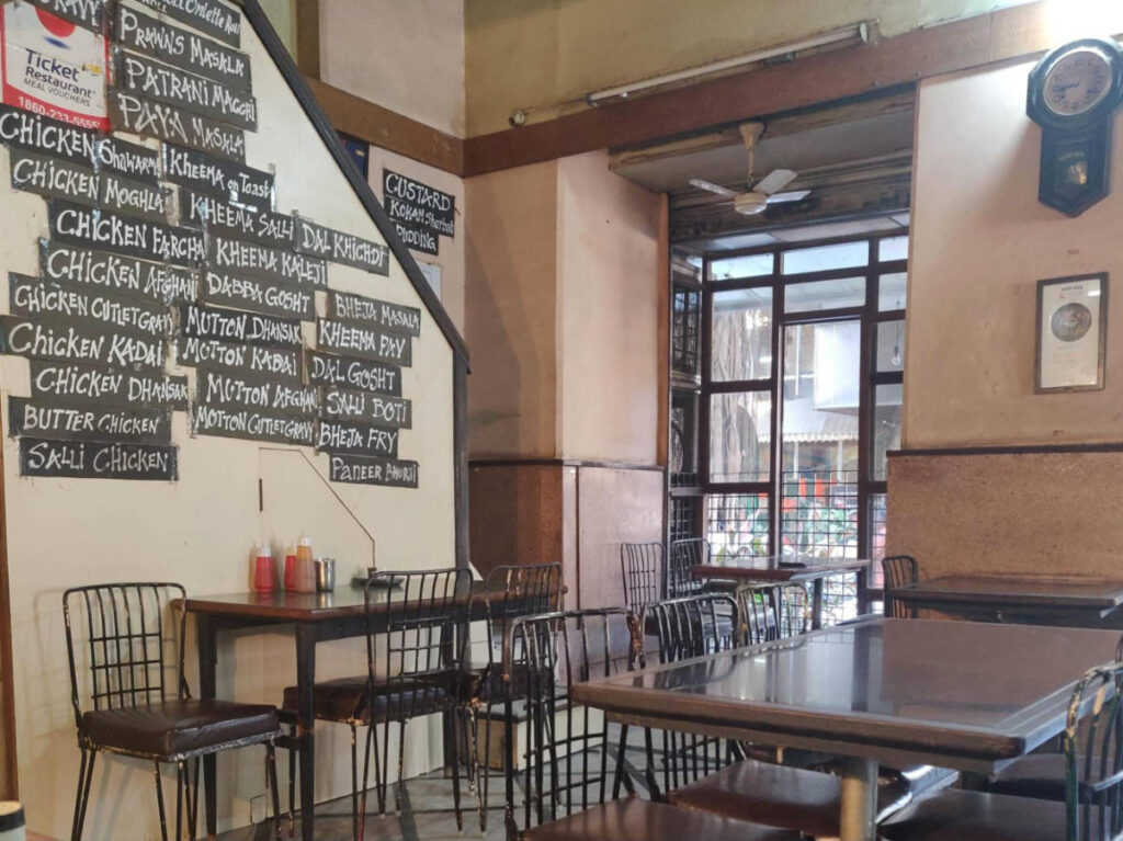 View of the rustic interior and a chalkboard-style menu in Cafe Excelsior