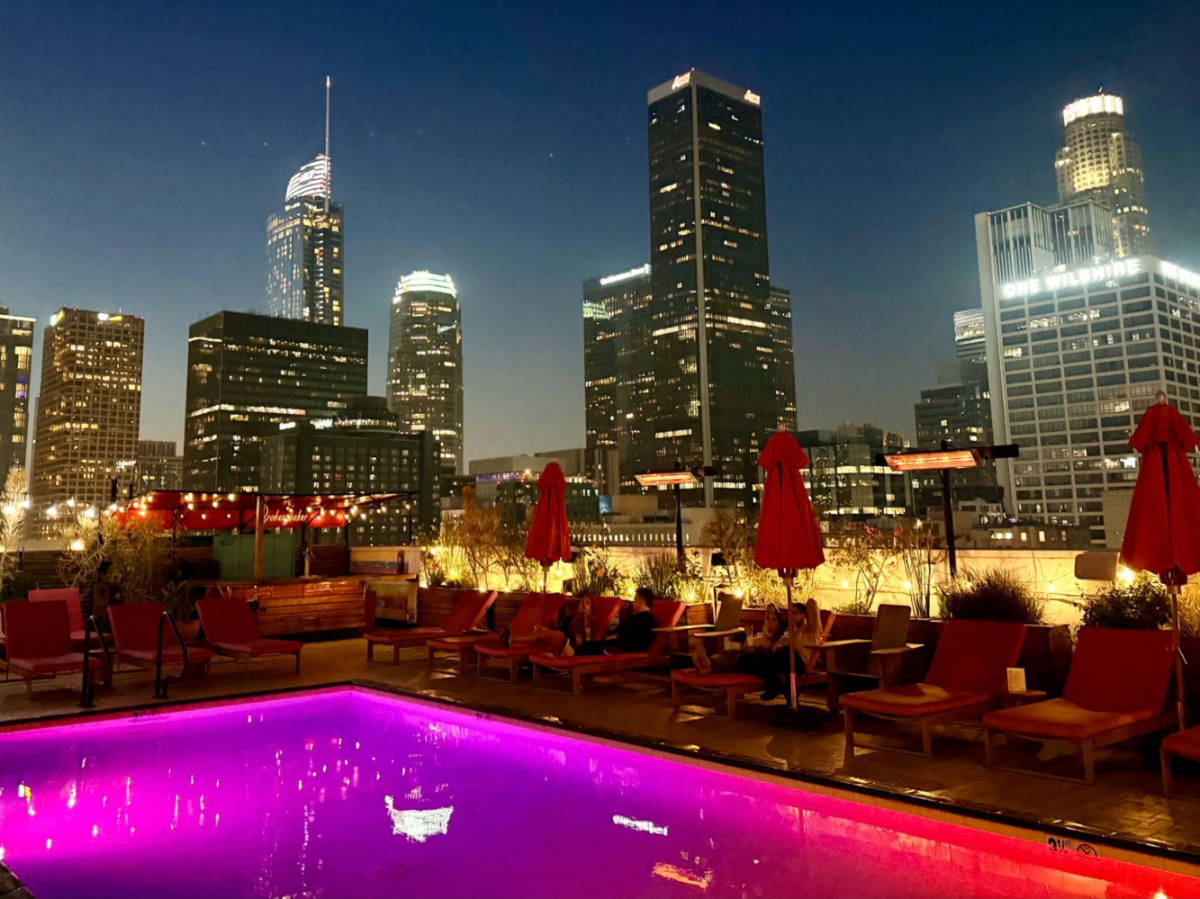 Scenic view of the high rises from the bright pink rooftop pool at night