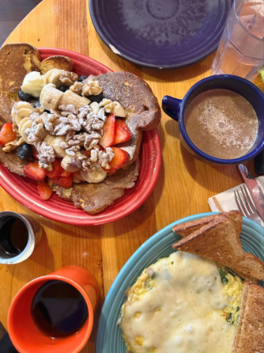 A plate of French toast and other breakfast meal with hot chocolate at Butterhorn Bakery