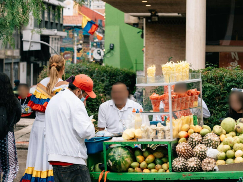 People in front of a fruit stall in Bogotá