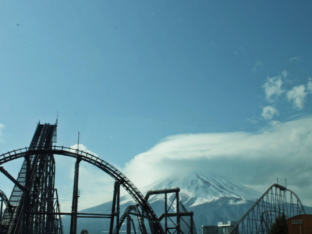 A roller coaster ride in Fuji-Q Highland Theme Park with Mount Fuji on the background