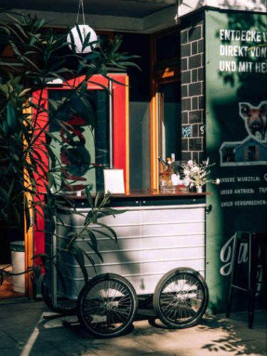 A funky and small bar behind the foliage