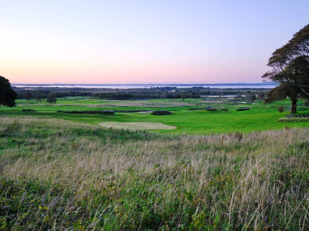 Panoramic view of the golf course surrounded by lush greenery