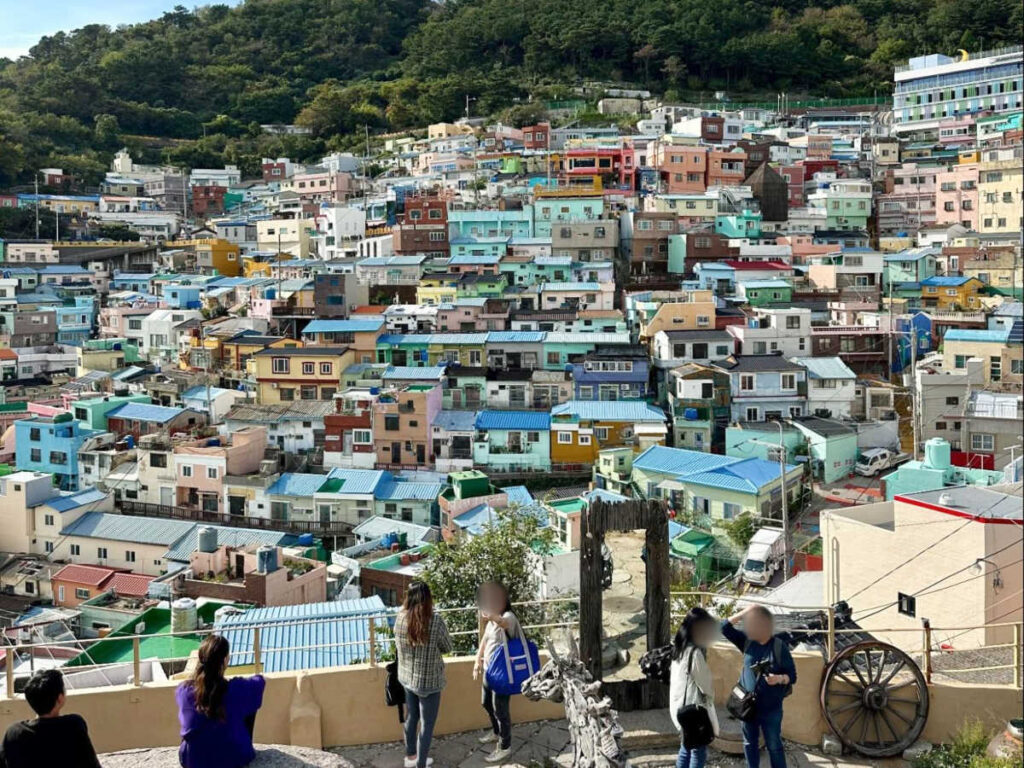 Tourists taking a photo with the colorful Gamcheon Culture Village