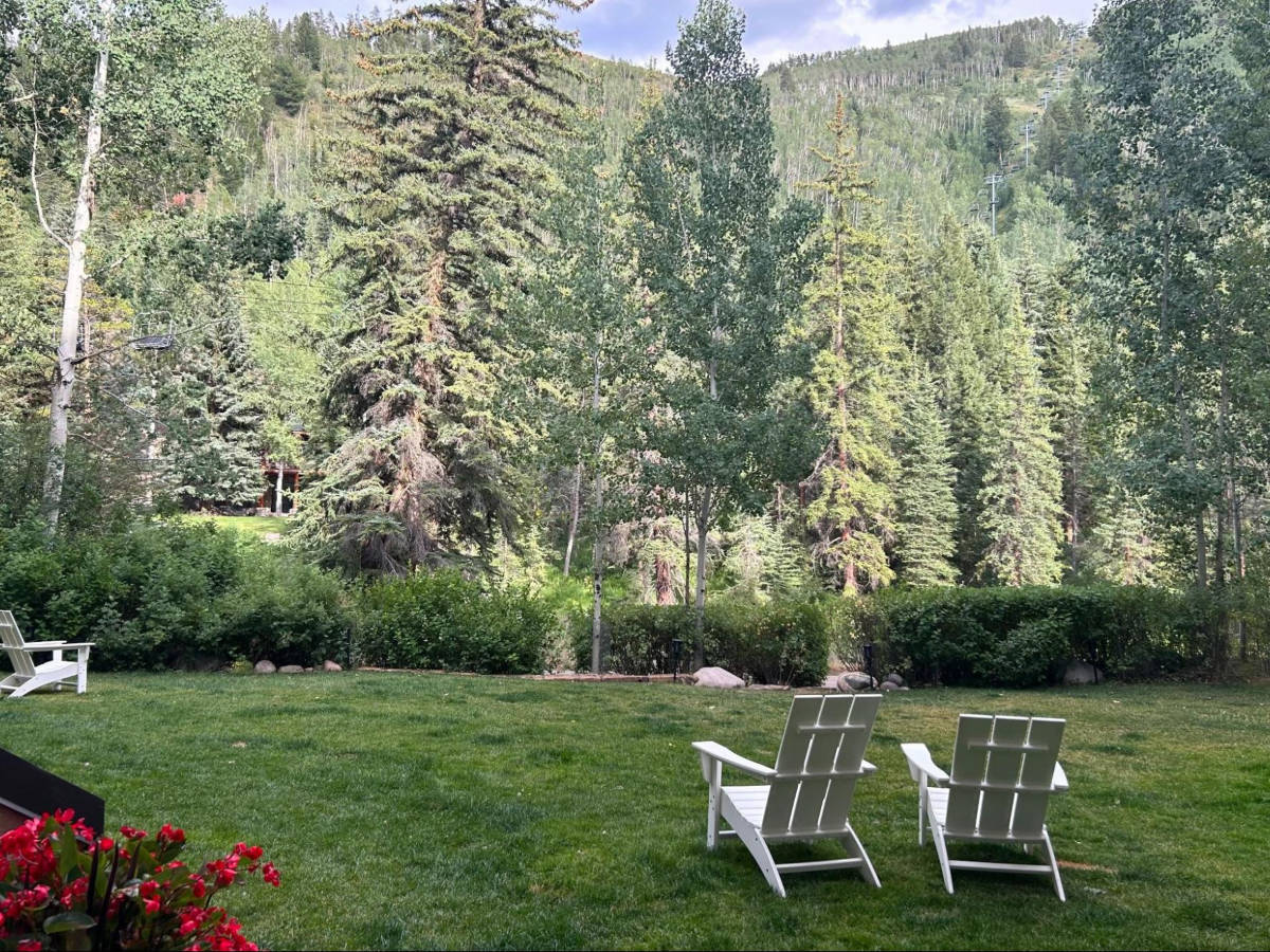 View of the lounge chairs surrounded by greenery in the garden of Grand Hyatt Vail