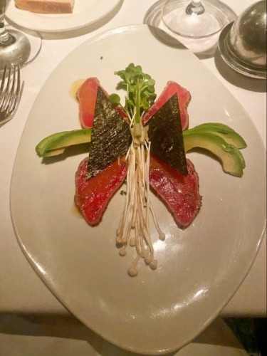 A seared ahi tuna on a plate served in Gary Danko