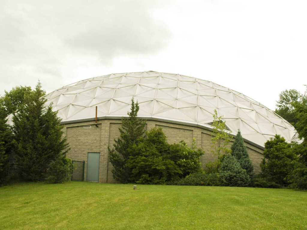 View of the top of geodesic dome and lush landscape  at Dinosaur State Park